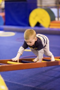 Small Boy Climbing Ladder on Obstacle Course